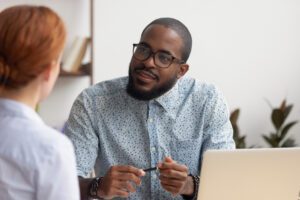 hr manager listening to female applicant asking questions at job interview 